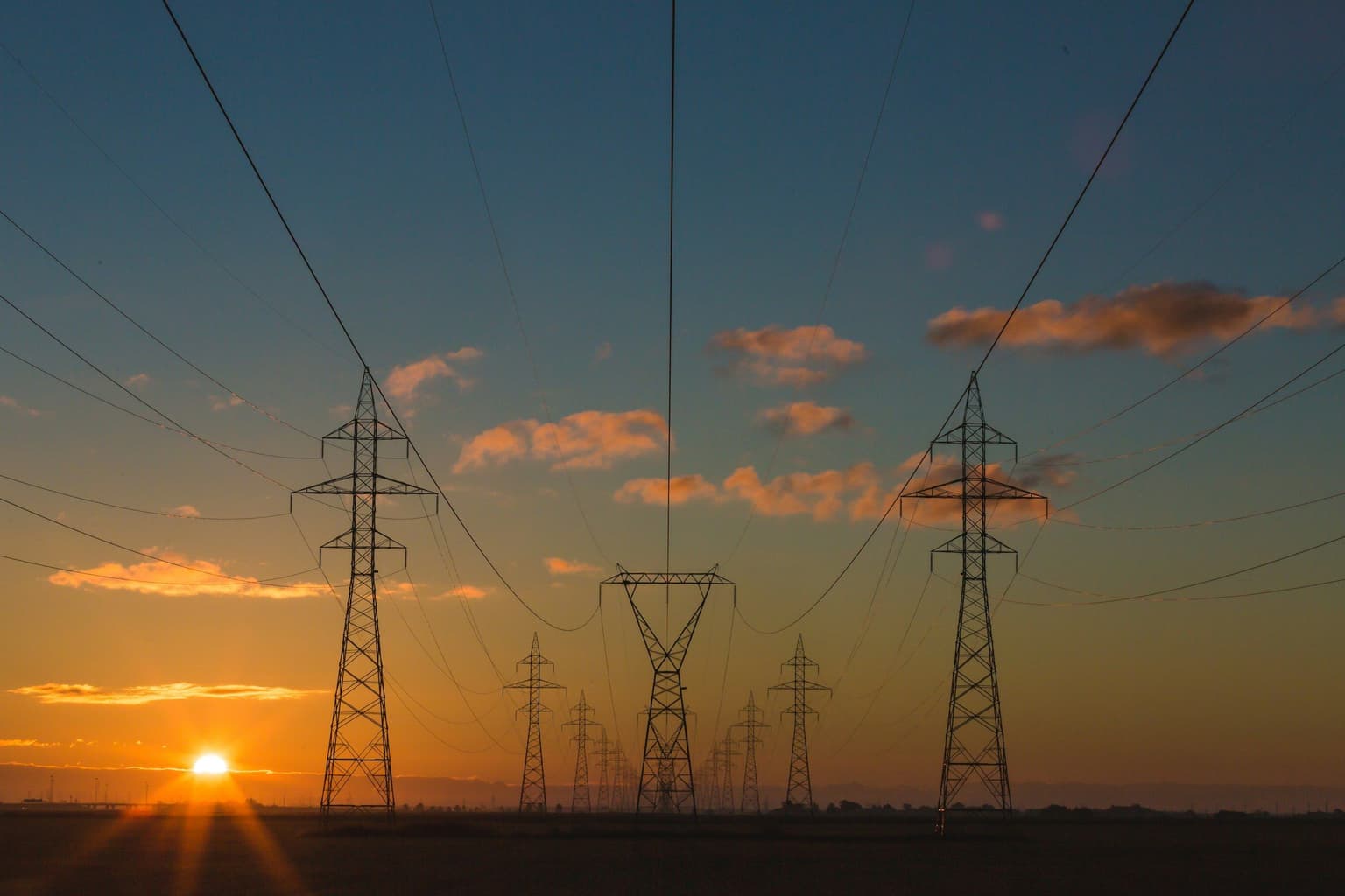 High-voltage transmission lines at sunset